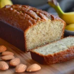 Freshly baked almond flour banana bread sliced on a wooden board