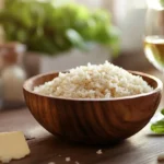 A bowl of raw Arborio rice with cooking ingredients.